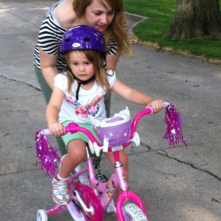 Kelly teaching Loretta to ride a bike, back in the states.