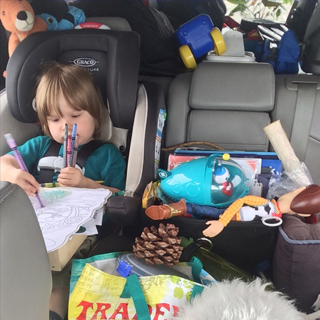He colors in the car.